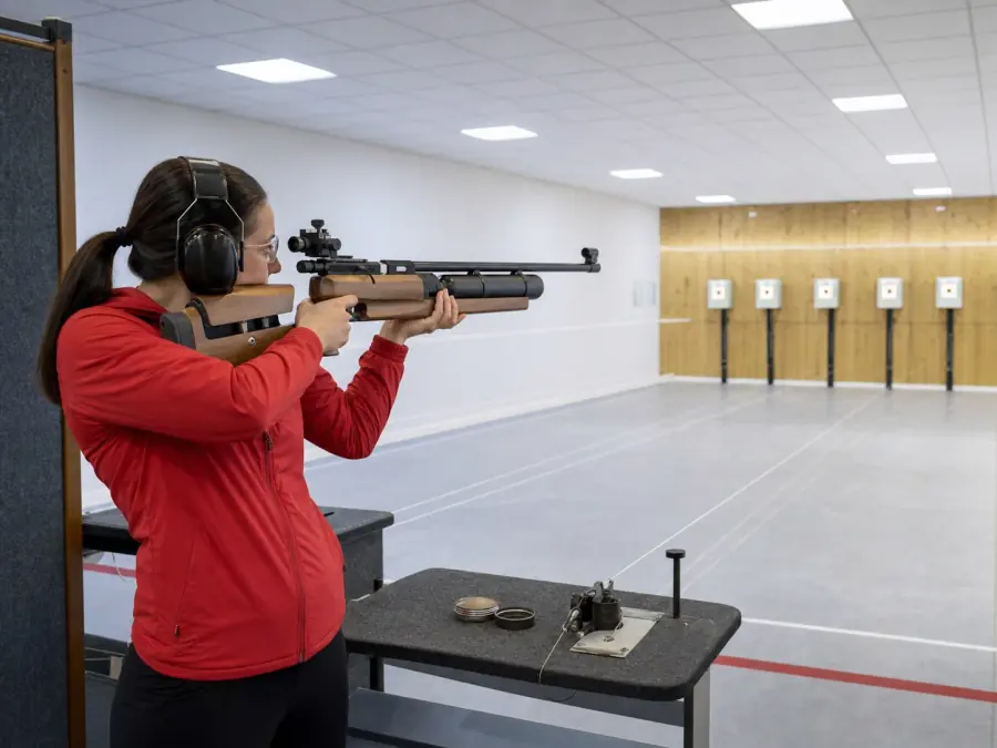 Shooter lining up a shot on an indoor air rifle range